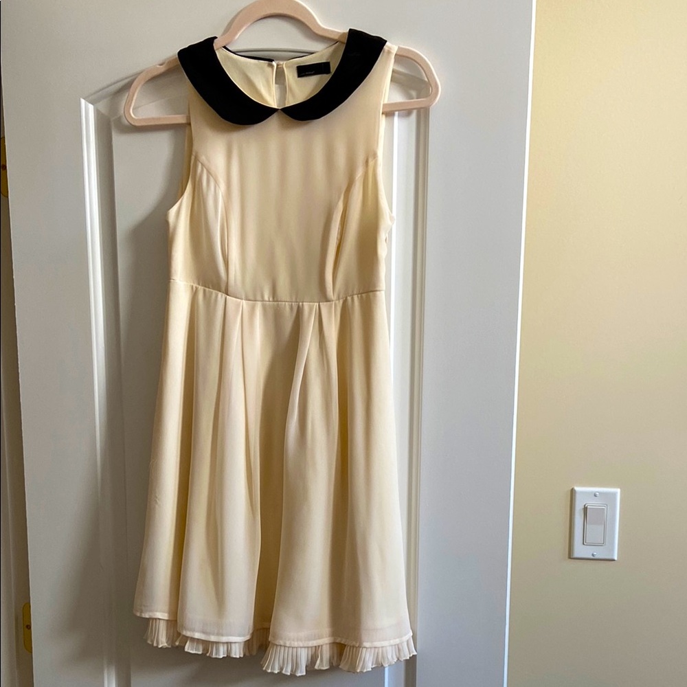 Elegant Cream Dress with Black Collar